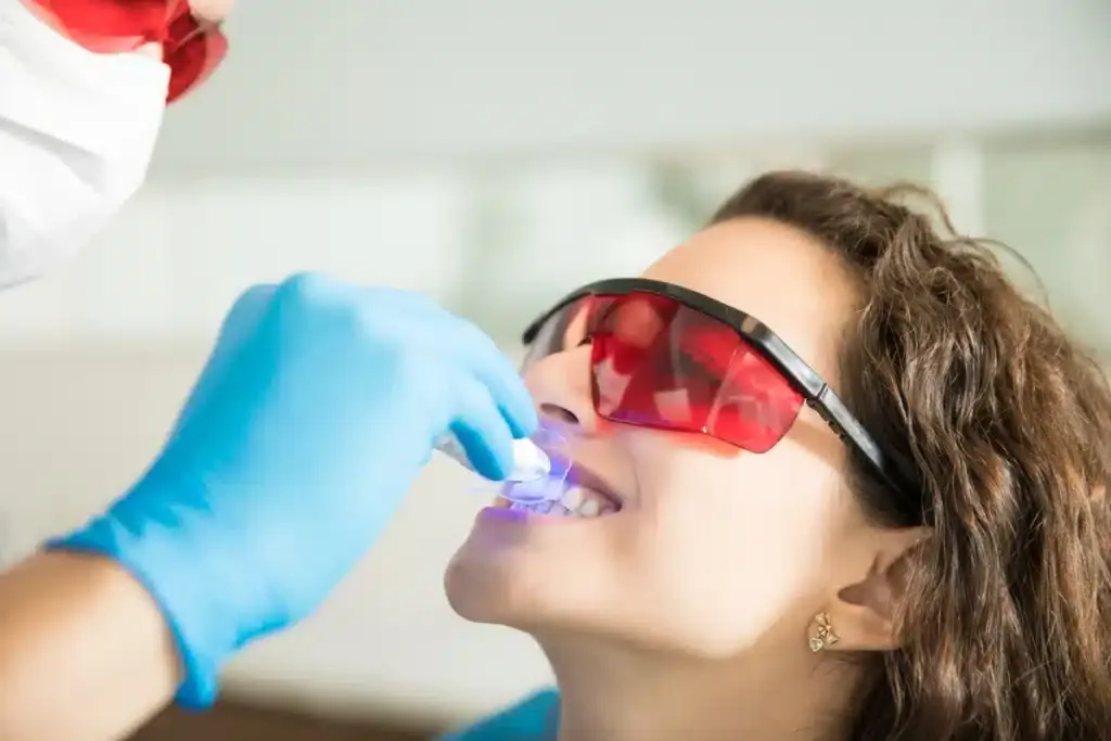 Woman using one of her teeth whitening options