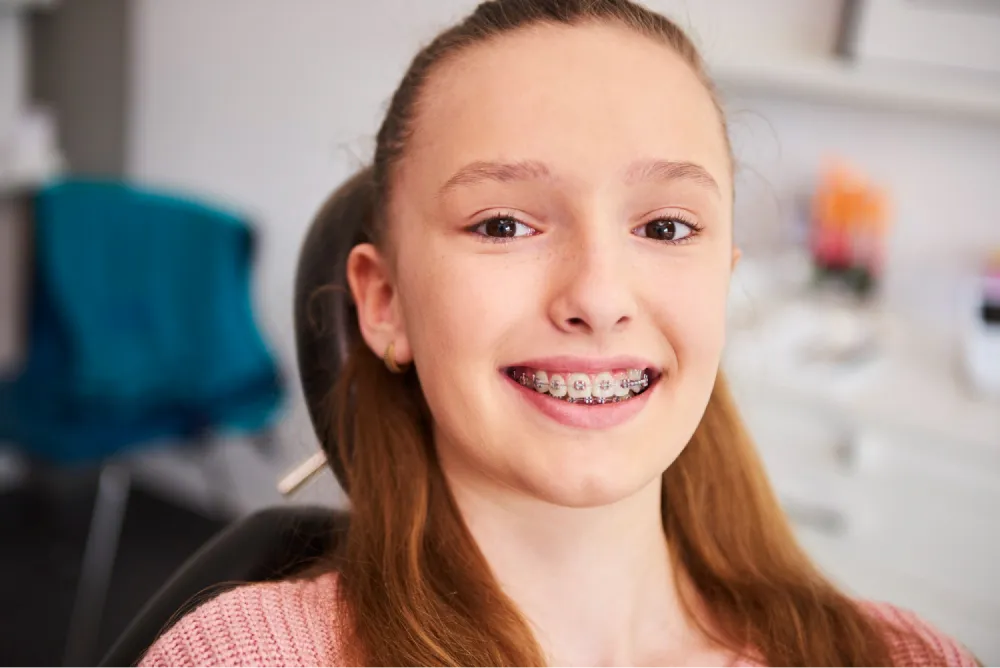 A teen smiling with braces