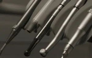 Fix Cavities Without a Drill or Shots 1 The image shows a variety of dental tools on a shelf in a dental office.