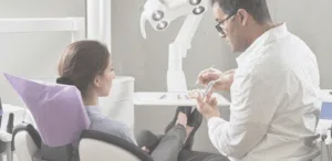 The Cat’s out of the Bag: Dentists Know You Don’t Floss 1 image of a dental office and a women receiving a treatment in dental hospital