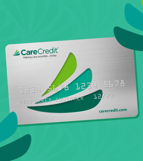 A CareCredit credit card on a green background.
