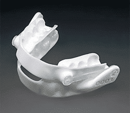 A white mouth guard on a black background.
