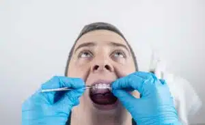 Laser Cavity Detection, how many hidden cavities do you have? 1 Dentist performing oral examination with tools.