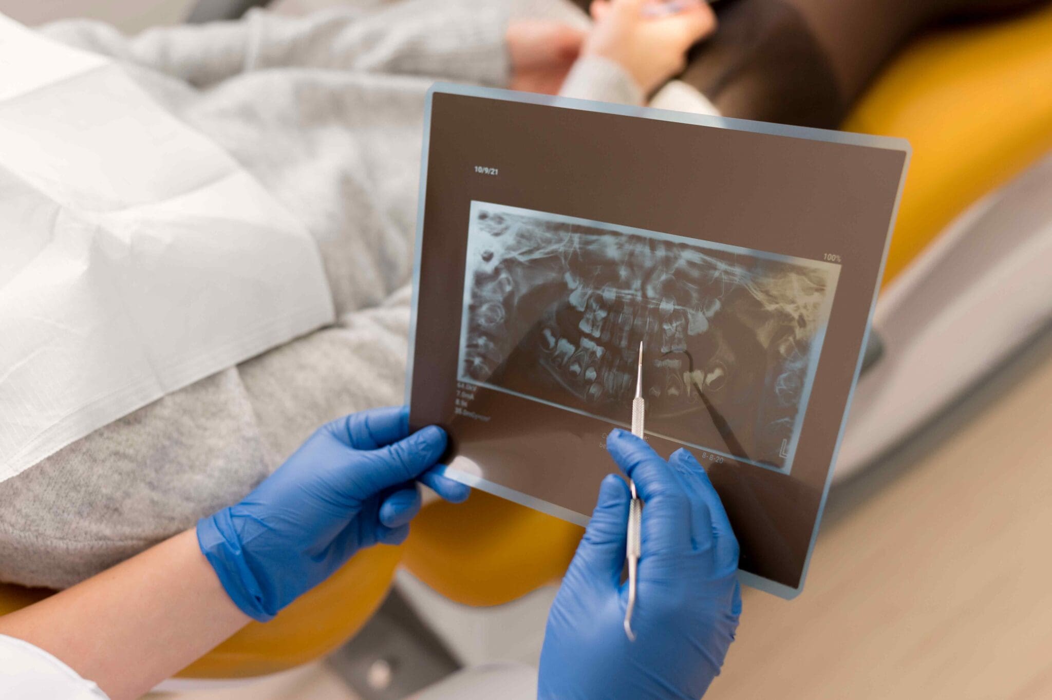 Advanced Dental Technology 11 A dentist shows a teeth X-ray to a patient.