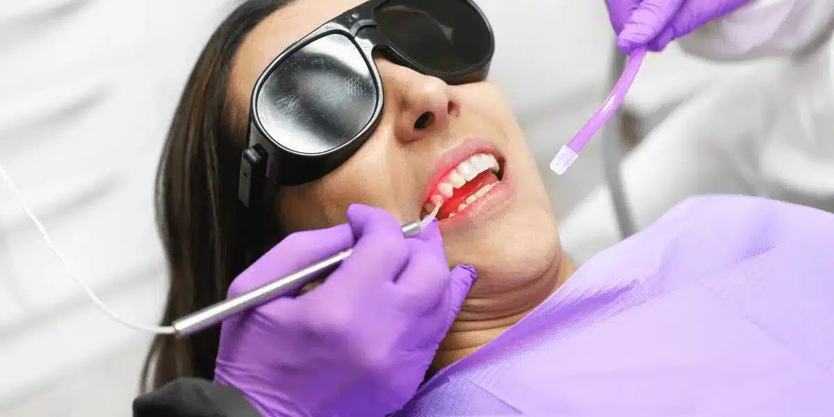 image of a woman receiving treatment of Low Light Laser Therapy In Dentistry at a dentist's hospital.