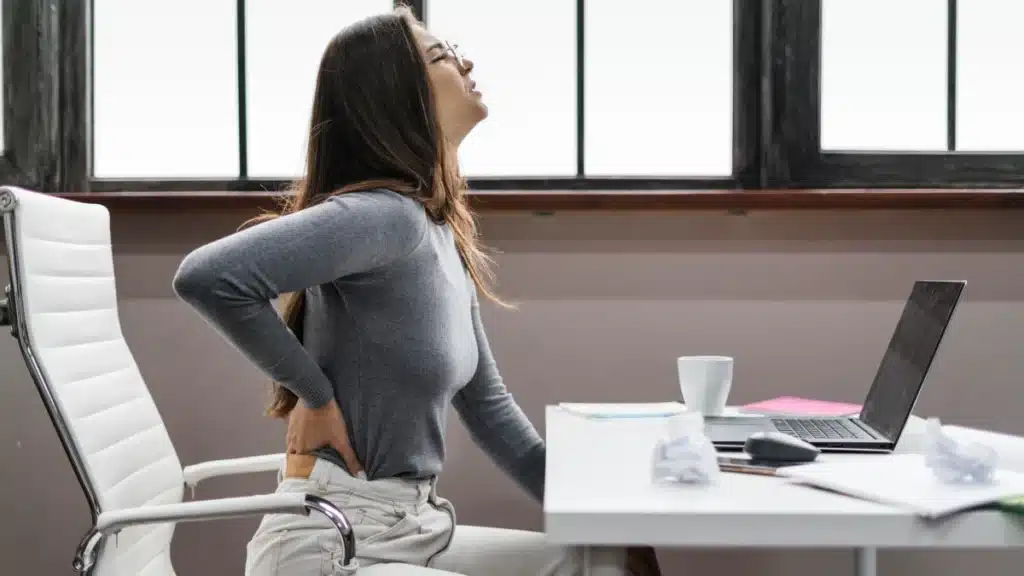 Woman fixing posture to relieve pain.