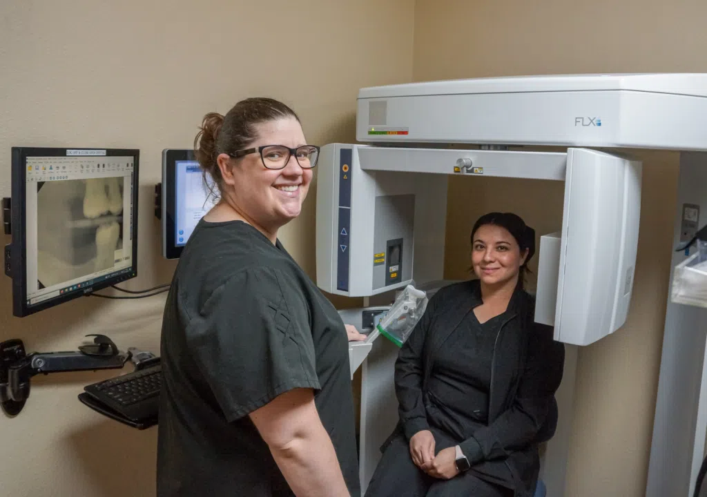 How to Get Rid of TMJ Ear Fullness 3 Dentist aiding a patient with ear pain