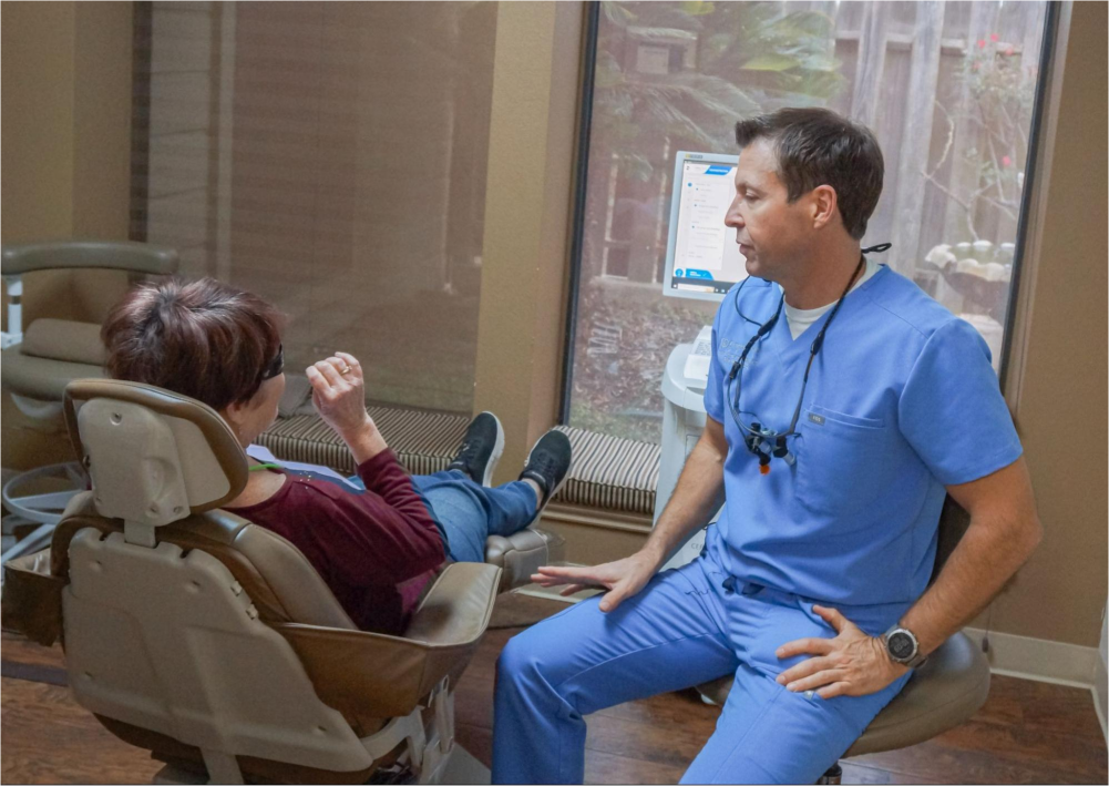 Dentist speaking with patient.