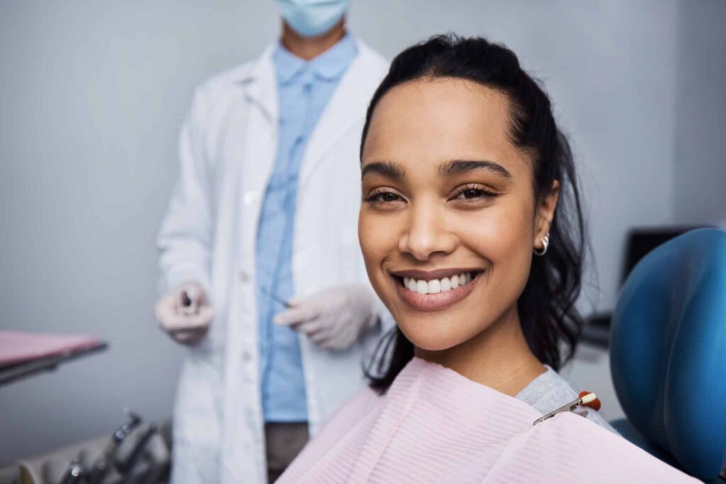 Woman smiling at dentist with bright teeth.