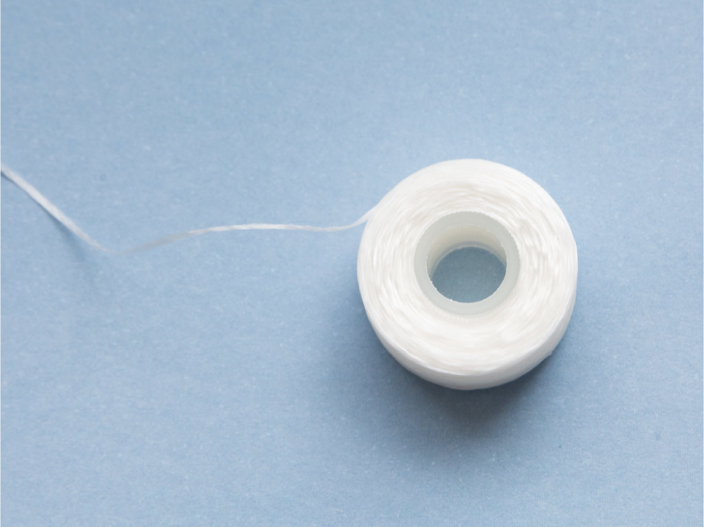 Dental floss on blue background