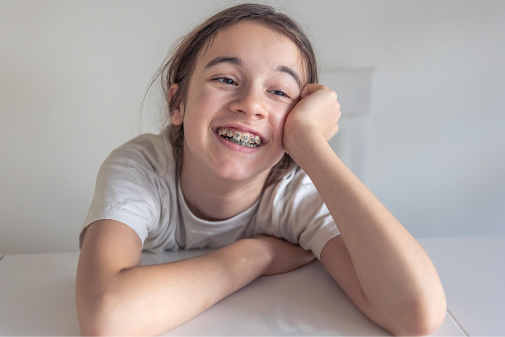 Child smiling with dental braces.