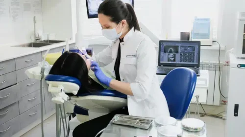 Image of a woman receiving a treatment from the dentist